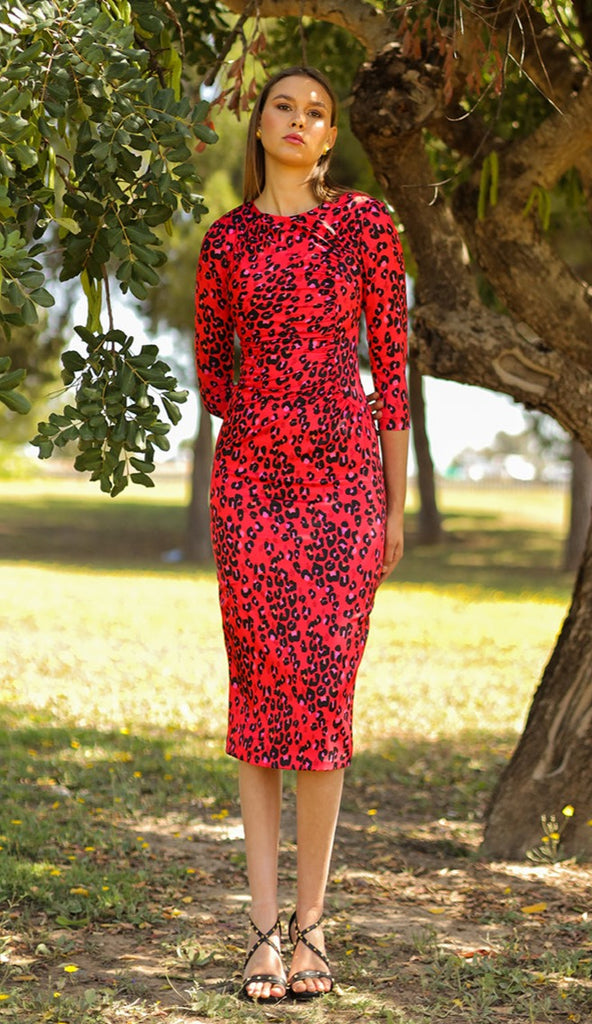Fitted midi dress with round neck, draped on the side and on the opposite side, and 3/4 sleeves. Made with red animal print elastic satin fabric.